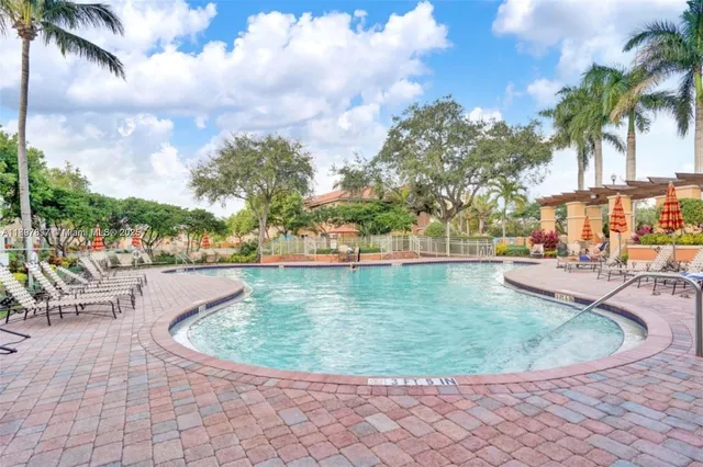 a view of a swimming pool with outdoor seating