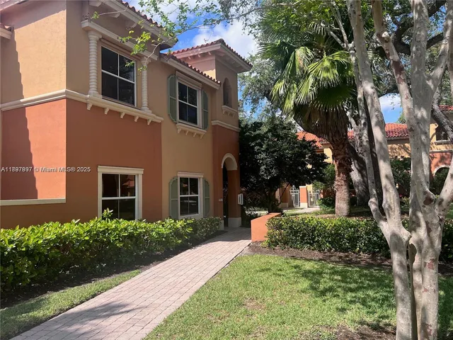 a front view of a house with yard and green space