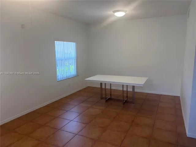 a view of a room with a table and a chair