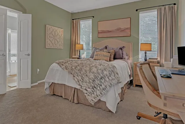 a bedroom with a bed and dresser