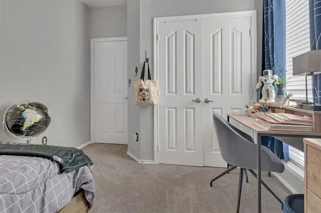 a bedroom with a bed and a television