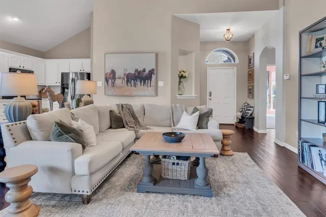 a living room with furniture a flat screen tv and a fireplace