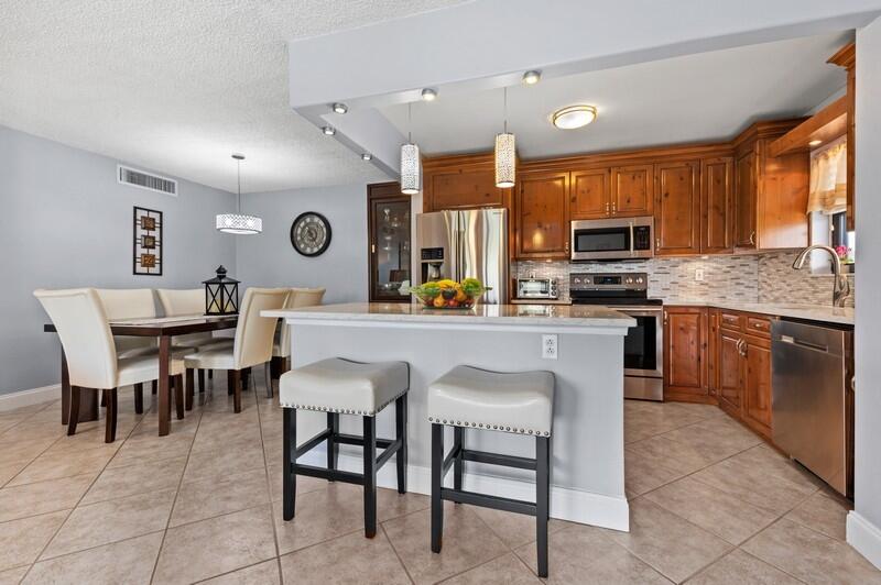 509 Dotterel Road, Unit 23C Delray Beach, FL 33444 - Photo 5 of 15 06_509DotterelRd_Apt23C_92_KitchenDining