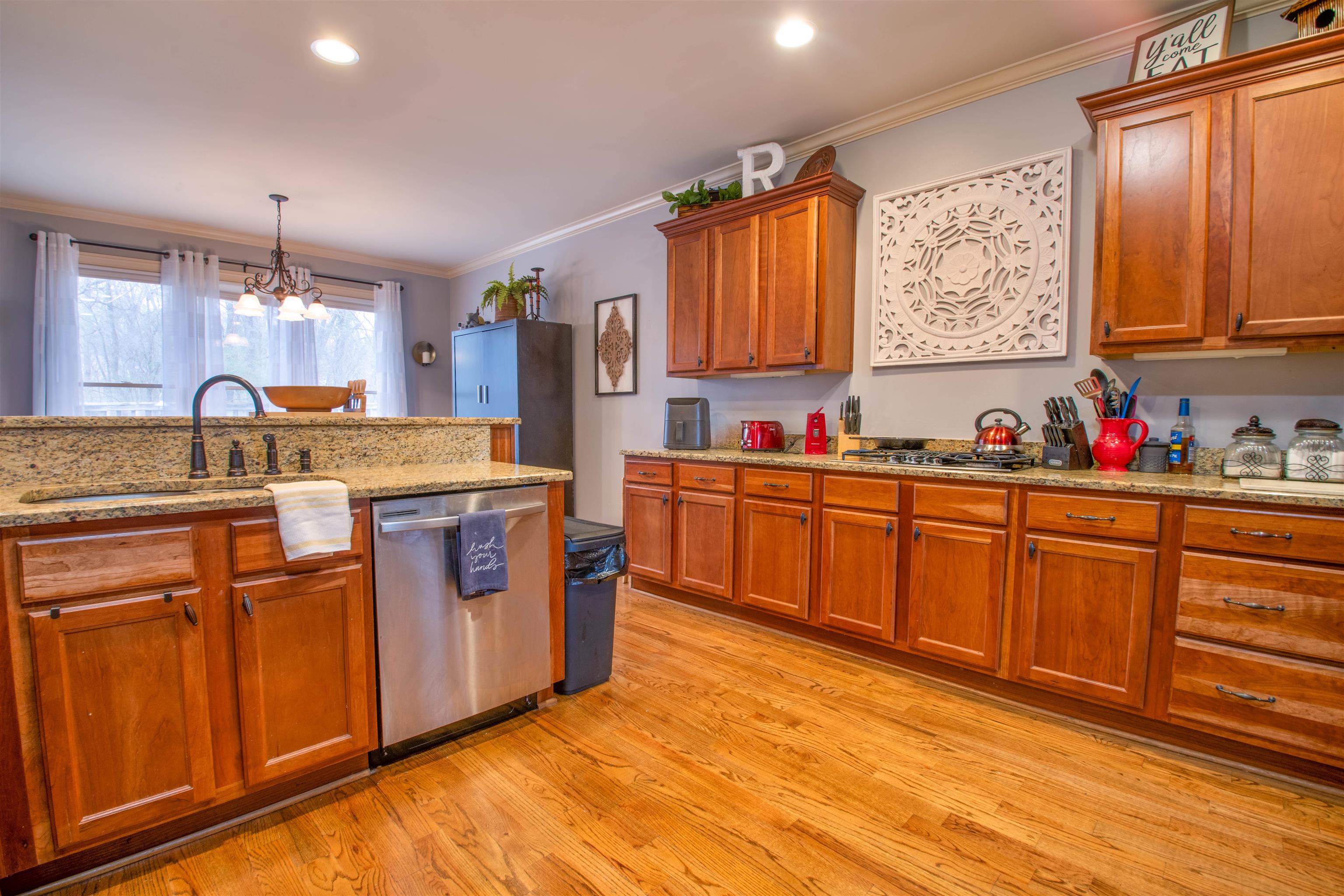 8722 Brunswick Forest Drive Bartlett, TN 38133 - Photo 13 of 38 Kitchen with sink, ornamental molding, light hardwood / wood-style floors, and dishwasher