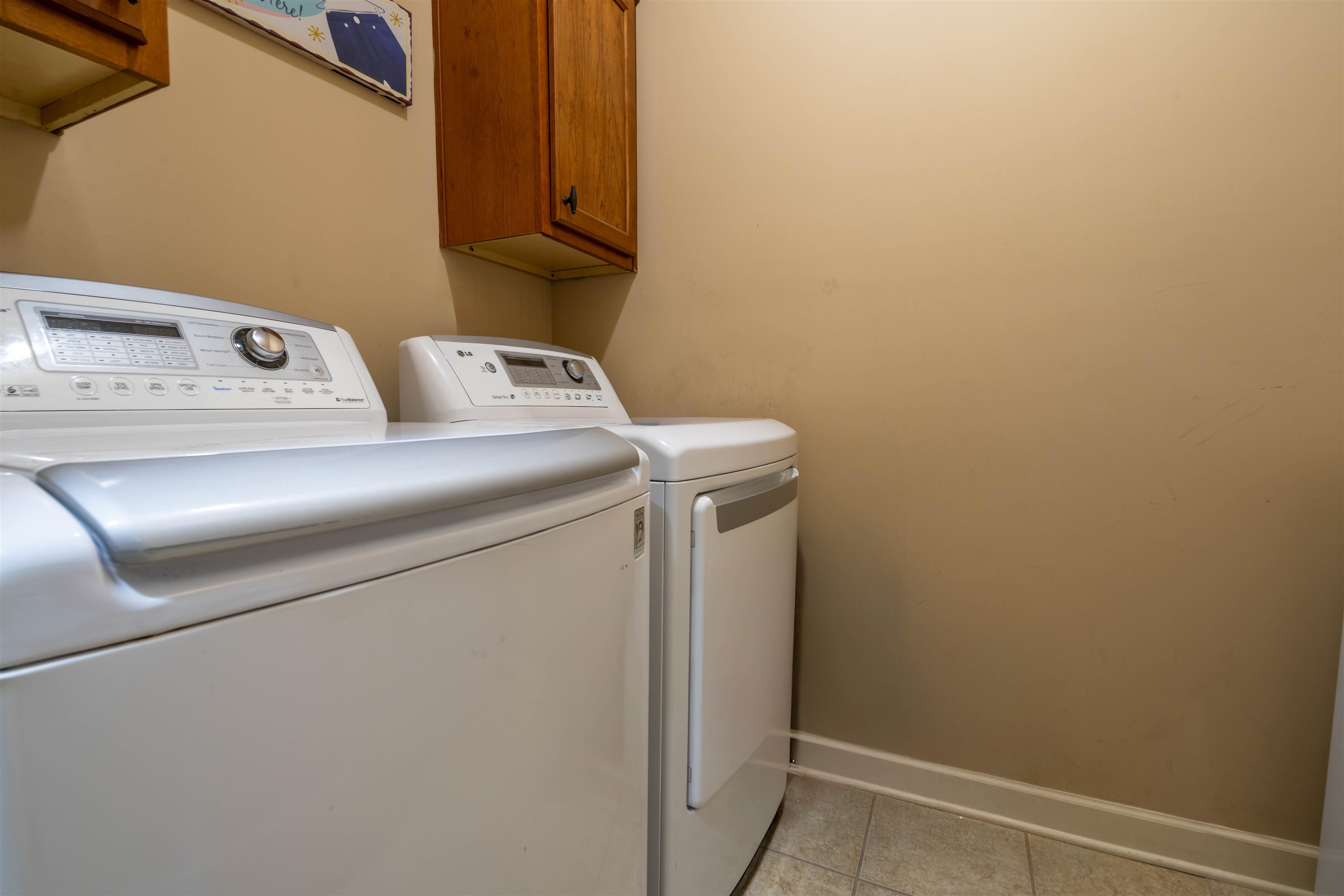 8722 Brunswick Forest Drive Bartlett, TN 38133 - Photo 14 of 38 Washroom featuring cabinets, washing machine and clothes dryer, and light tile patterned flooring
