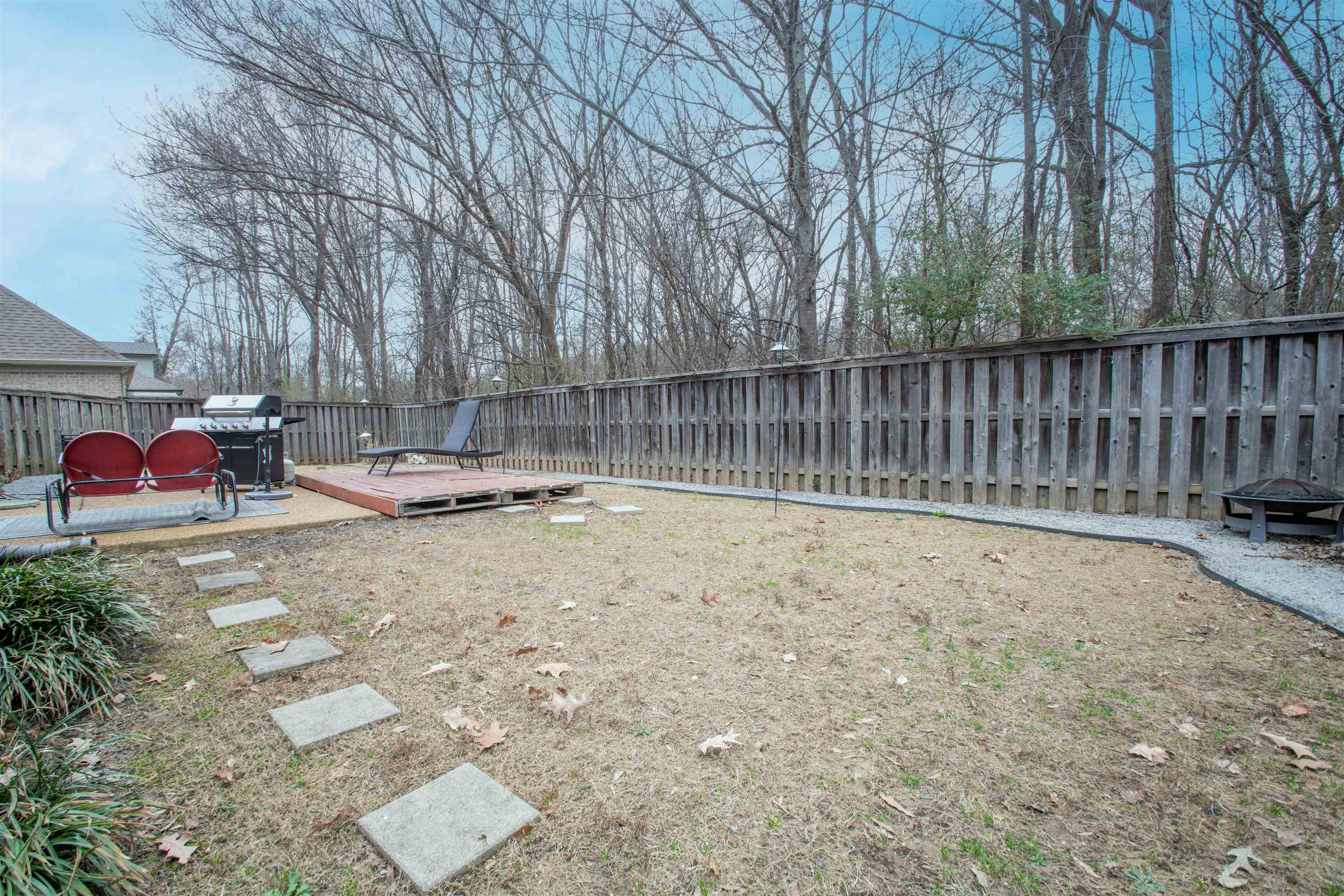 8722 Brunswick Forest Drive Bartlett, TN 38133 - Photo 34 of 38 View of yard featuring a deck and an outdoor fire pit