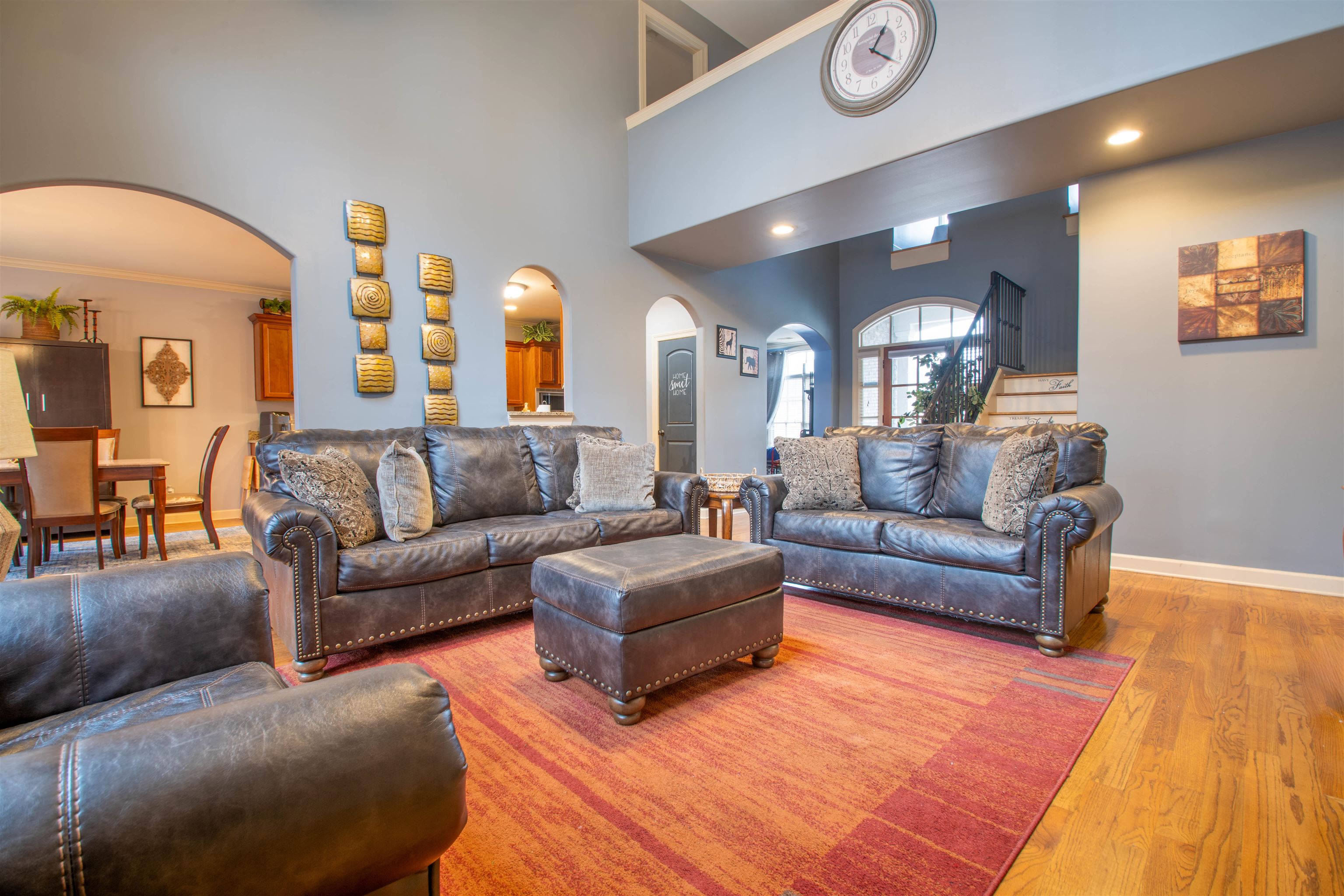 8722 Brunswick Forest Drive Bartlett, TN 38133 - Photo 7 of 38 Living room with ornamental molding, a high ceiling, and light wood-type flooring