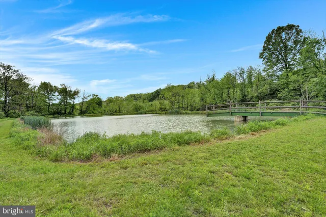 a view of a lake with houses in the back