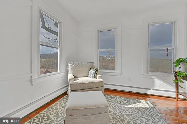 a living room with a couch and next to a window