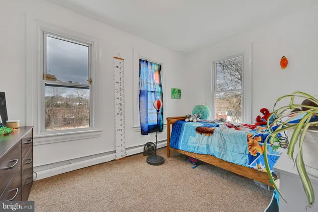 a bedroom with furniture and a window