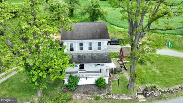an aerial view of a house with a yard