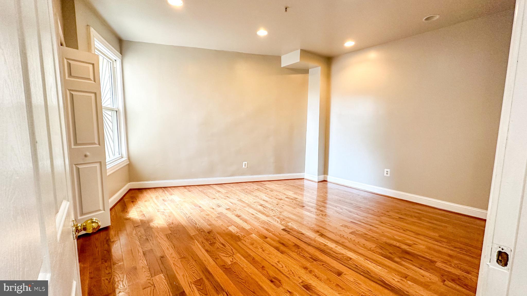 3408 Sherman Avenue Northwest, Unit 101 Washington, DC 20010 - Photo 11 of 15 a view of an empty room with wooden floor