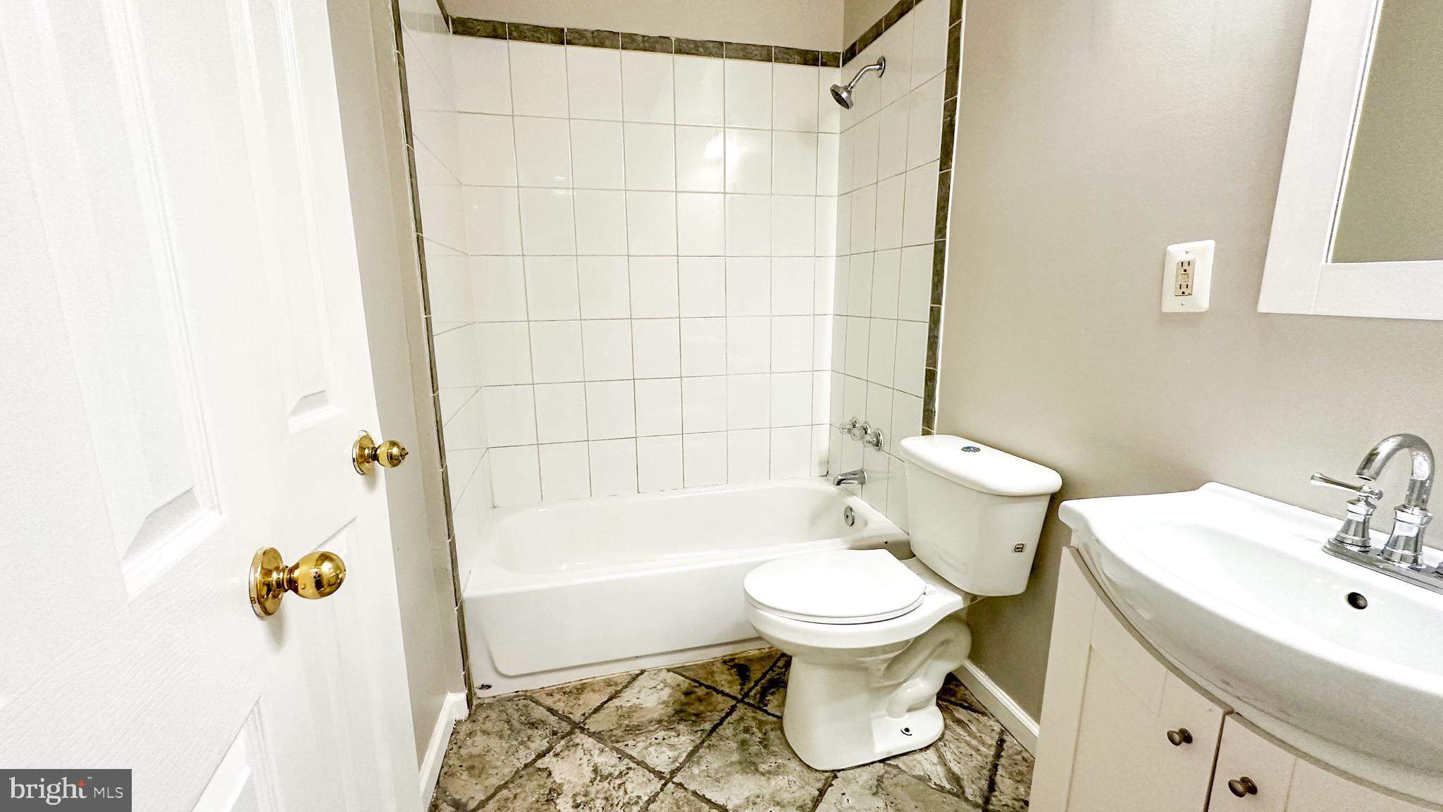 3408 Sherman Avenue Northwest, Unit 101 Washington, DC 20010 - Photo 13 of 15 a bathroom with a sink toilet and shower