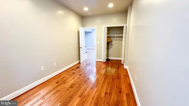 a view of a room with wooden floor and staircase