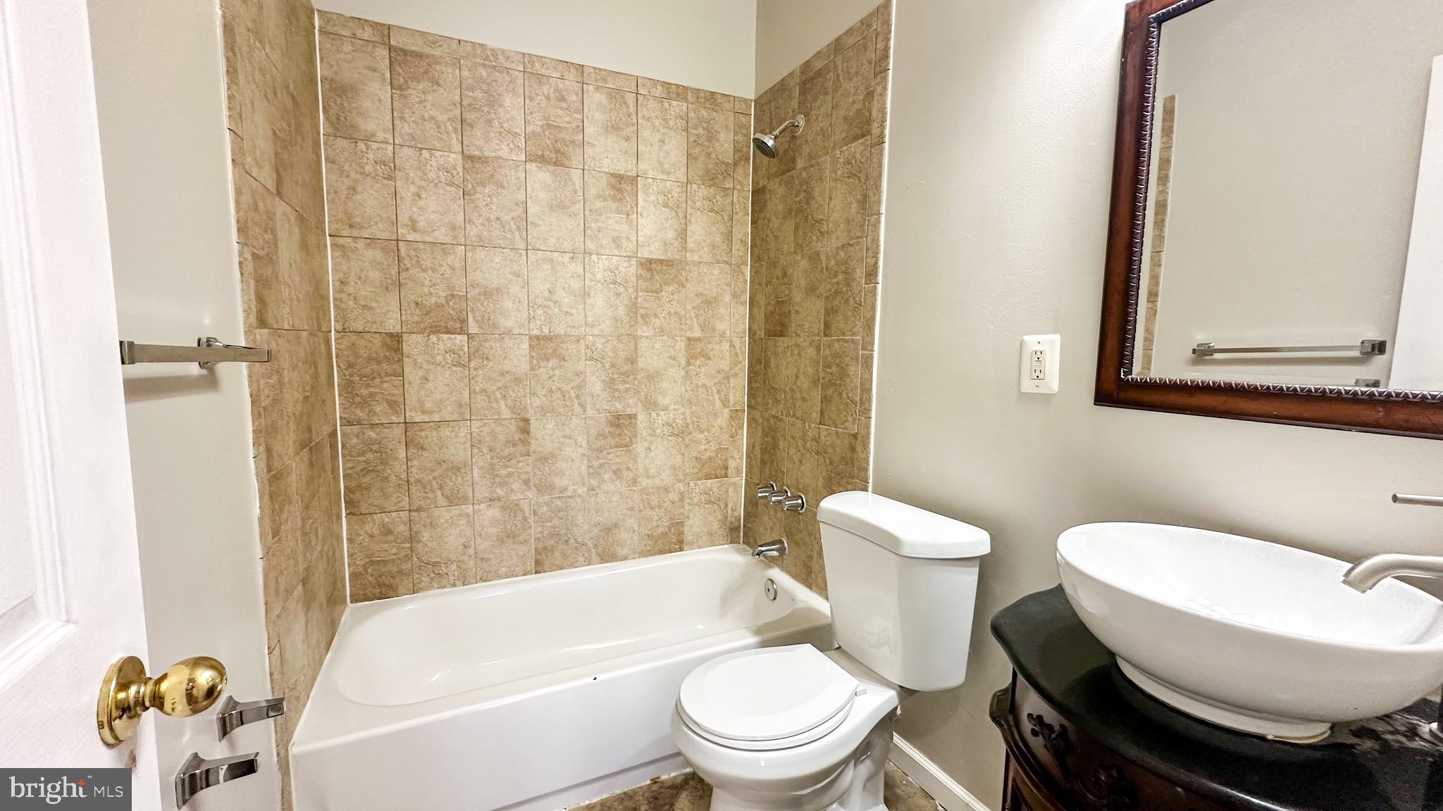 3408 Sherman Avenue Northwest, Unit 101 Washington, DC 20010 - Photo 10 of 15 a white toilet sitting next to a bath tub