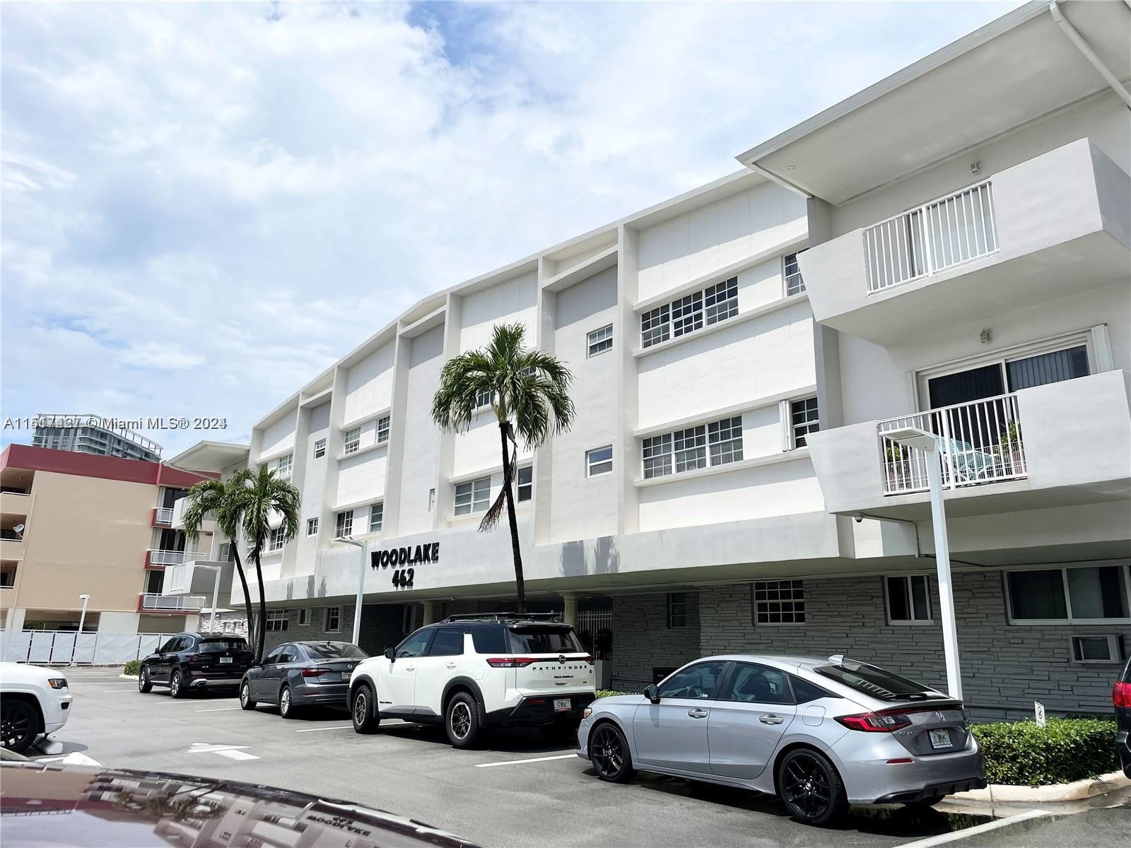 462 Golden Isles Drive, Unit 210 Hallandale Beach, FL 33009 - Photo 14 of 41 a front view of a building with parking space
