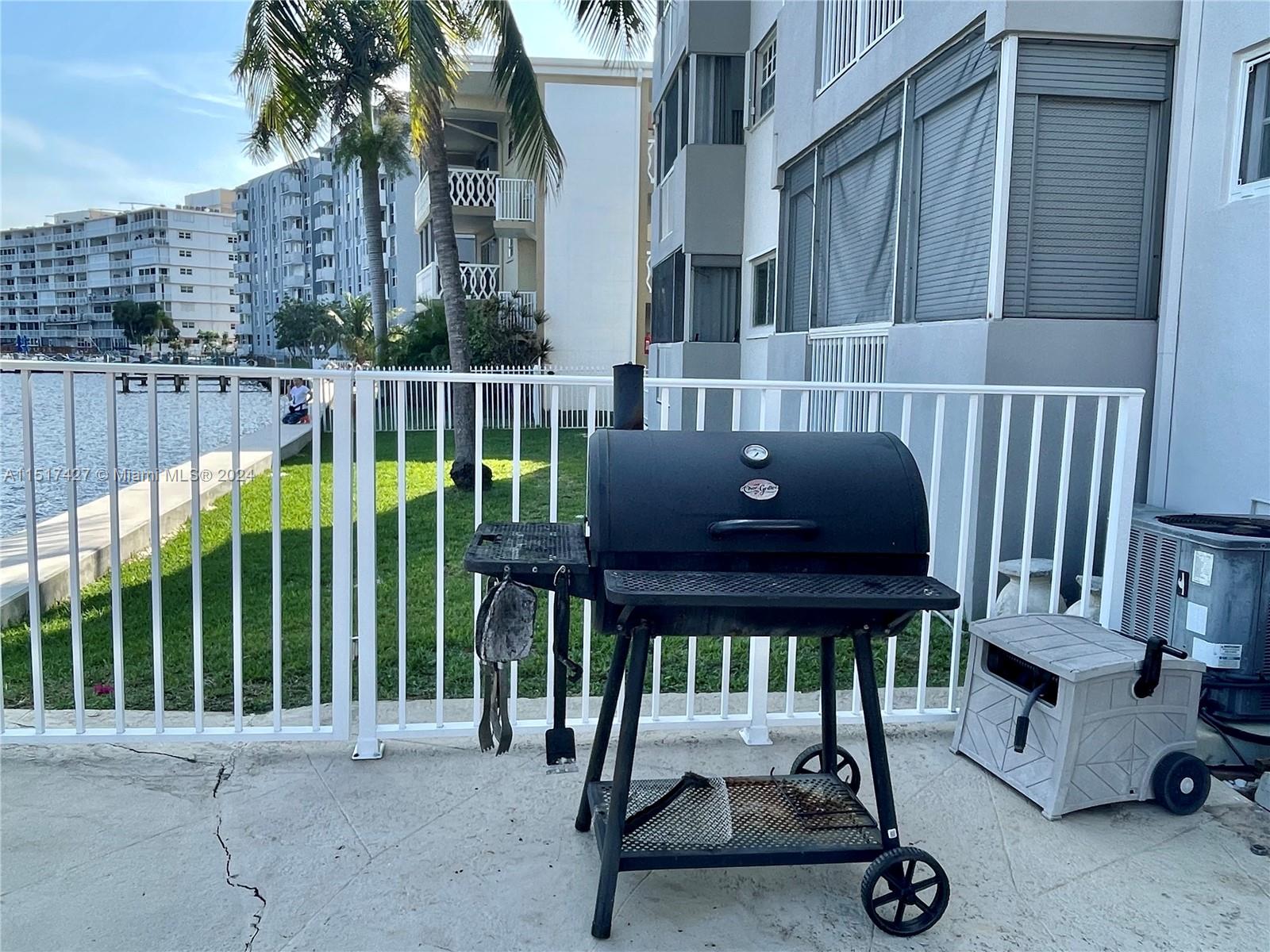 462 Golden Isles Drive, Unit 210 Hallandale Beach, FL 33009 - Photo 16 of 41 a view of balcony with two chairs and a potted plant