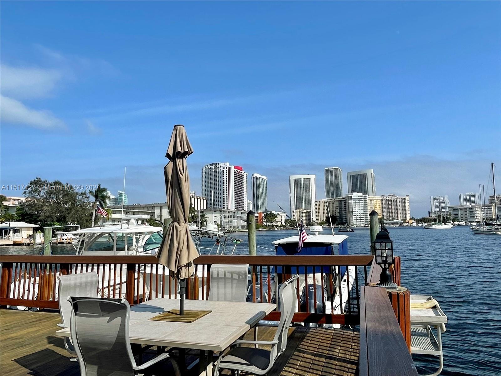 462 Golden Isles Drive, Unit 210 Hallandale Beach, FL 33009 - Photo 17 of 41 a view of a balcony with furniture