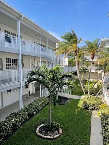 a kitchen with stainless steel appliances granite countertop a sink a stove a refrigerator and cabinets