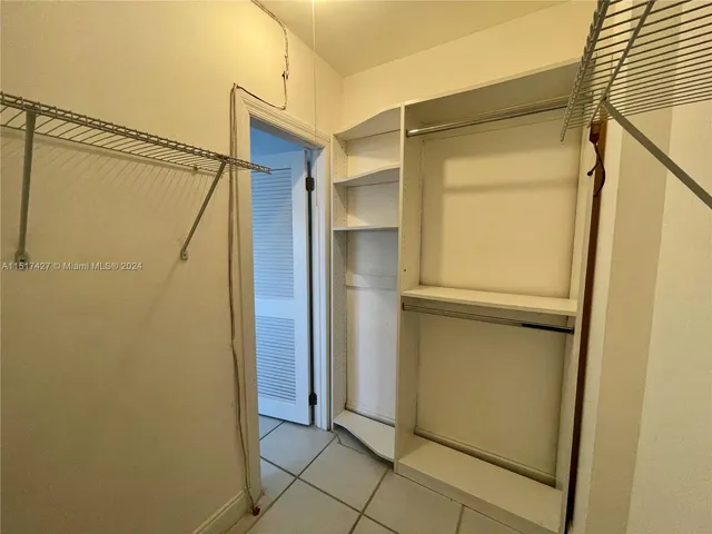 an empty room and chandelier fan view