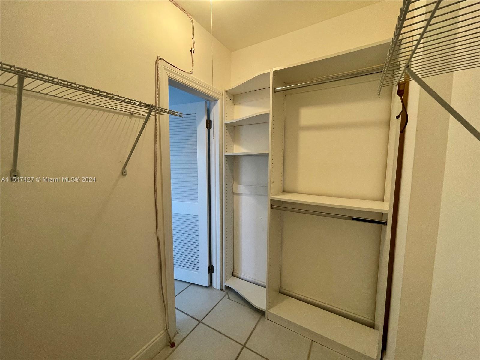 462 Golden Isles Drive, Unit 210 Hallandale Beach, FL 33009 - Photo 34 of 41 a bathroom with a shower and a door