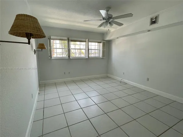 a kitchen with granite countertop a sink stainless steel appliances and white cabinets