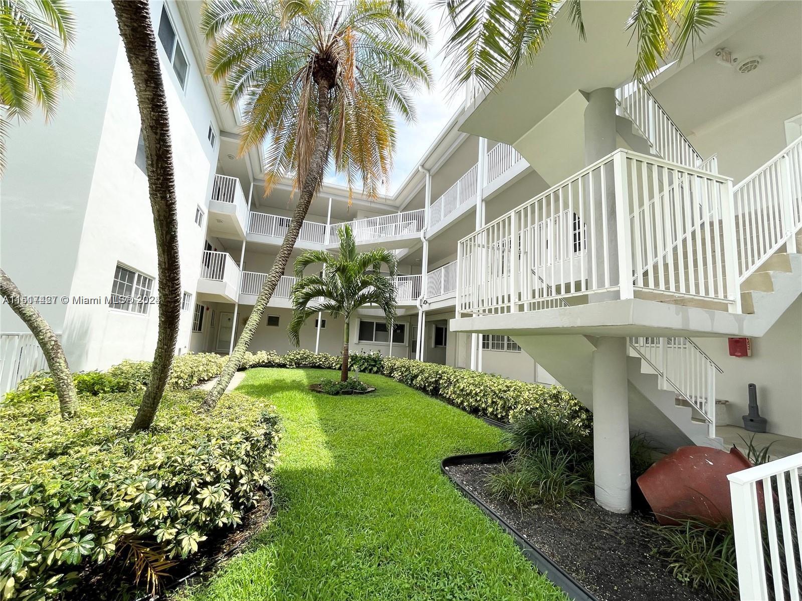 462 Golden Isles Drive, Unit 210 Hallandale Beach, FL 33009 - Photo 4 of 41 a front view of a house with garden