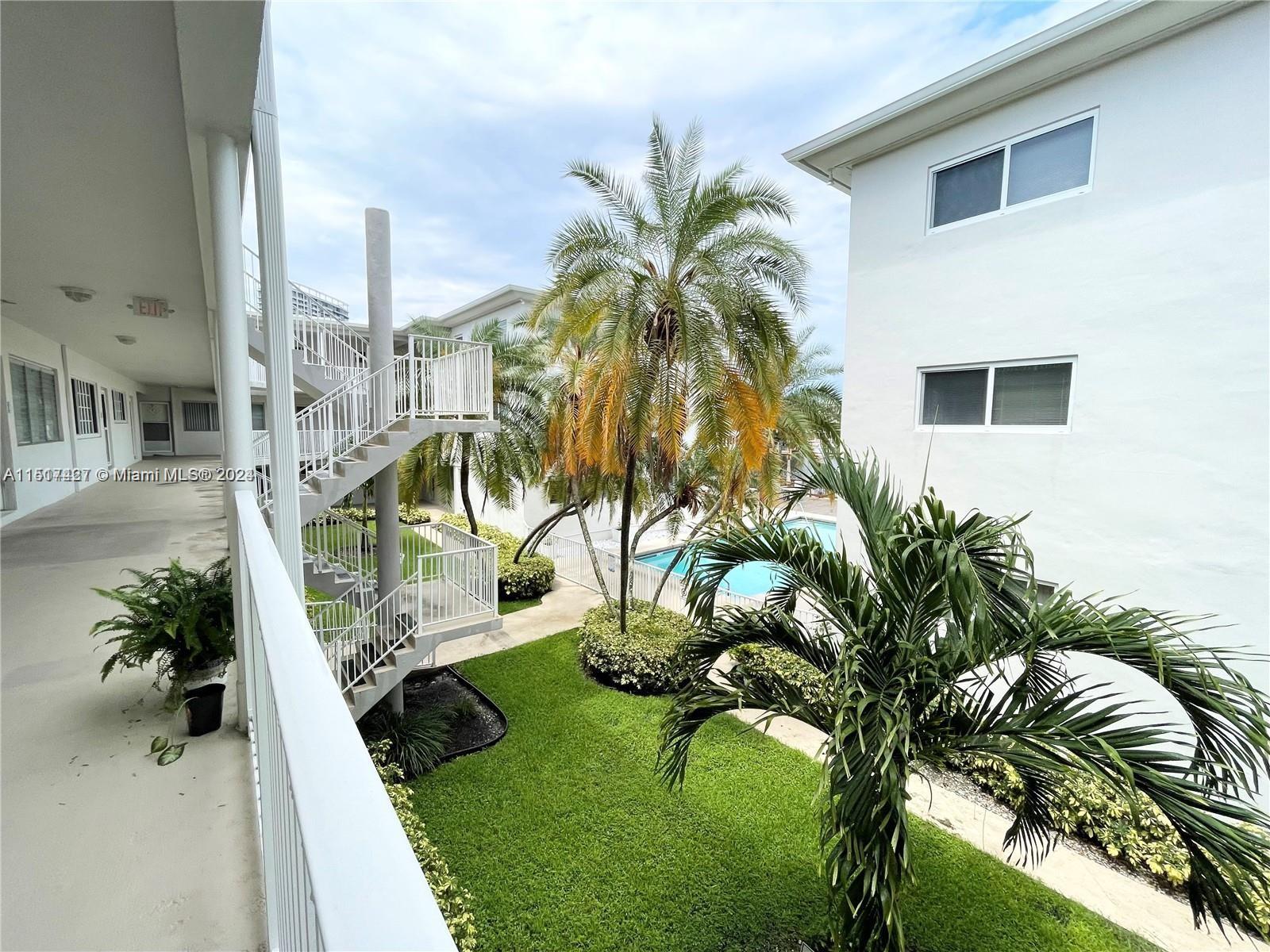 462 Golden Isles Drive, Unit 210 Hallandale Beach, FL 33009 - Photo 5 of 41 a view of a house with a yard