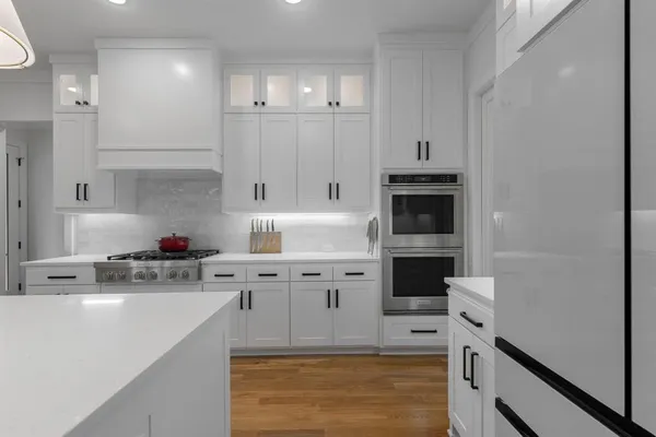 a kitchen with cabinets a window and a fireplace