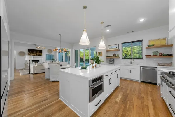 a kitchen with stove a sink and refrigerator