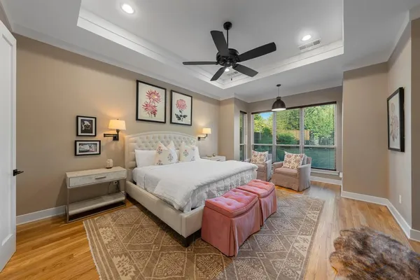 a spacious bedroom with a bed and a large window