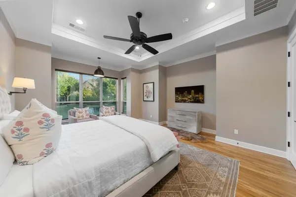 a spacious bedroom with a large bed and a large window