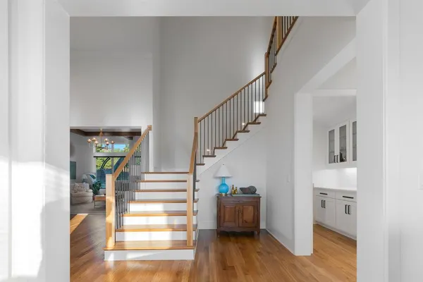 a view of entryway and hall with wooden floor
