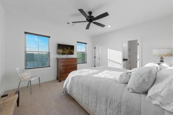a bedroom with a bed and a tv on the dresser