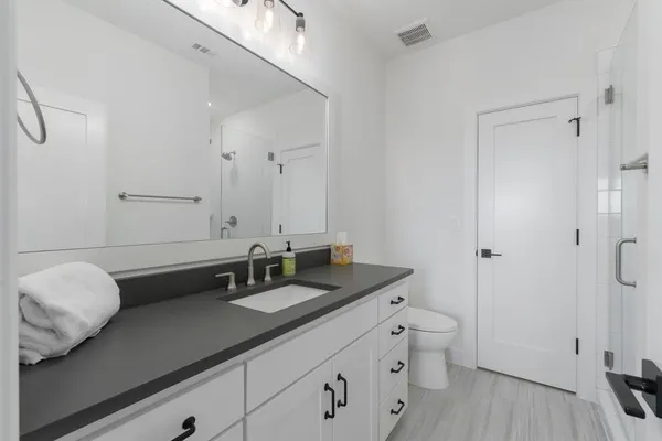 a bathroom with a double vanity sink and mirror