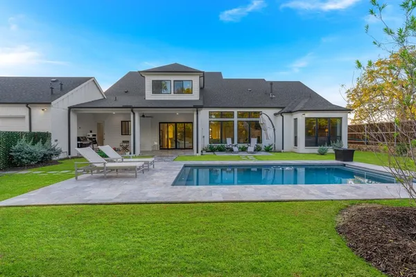a view of house with a swimming pool
