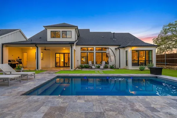 a view of a house with swimming pool and a porch