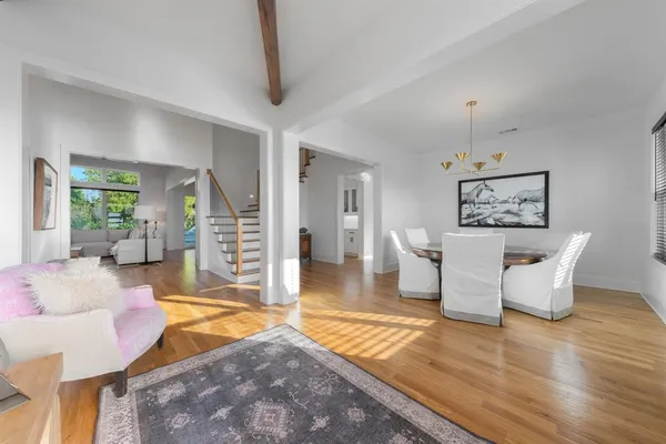 a living room with fireplace furniture and a wooden floor