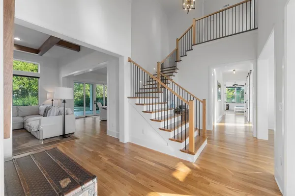a view of entryway livingroom and hall with wooden floor