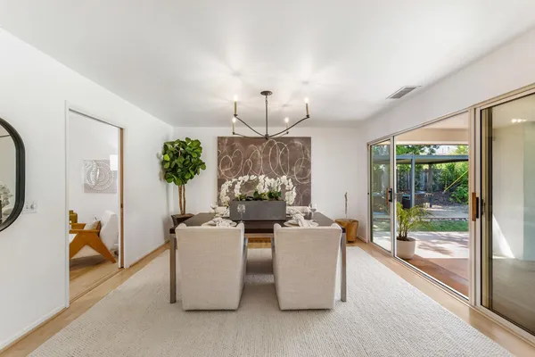 a living room with fireplace furniture and a chandelier