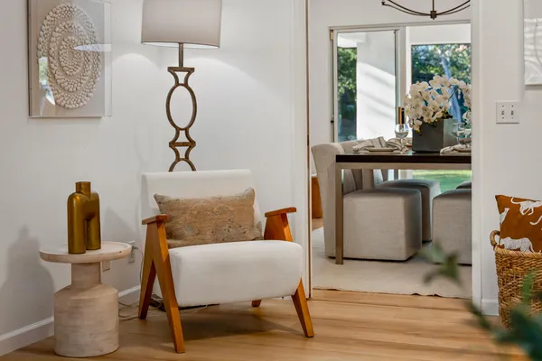 a living room with furniture a window and potted plants