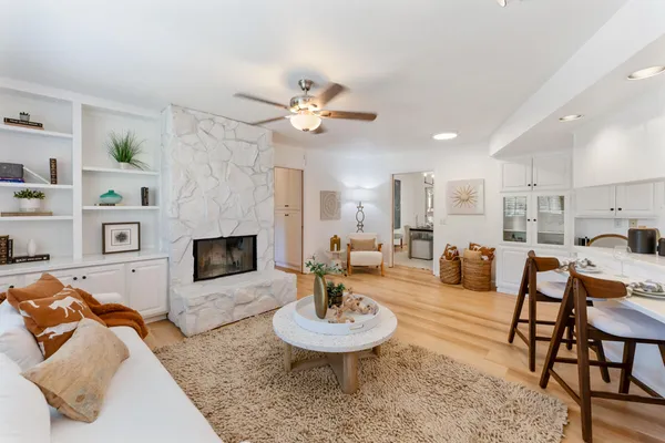 a living room with furniture a fireplace and a table