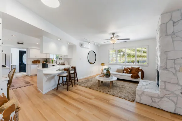 a living room with furniture fireplace and window