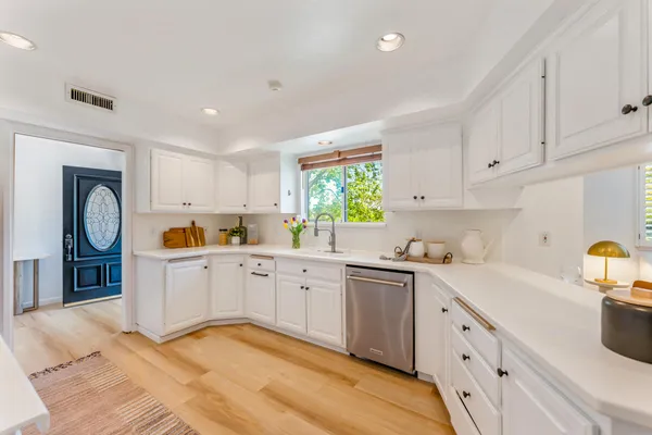 a kitchen with cabinets appliances and a window