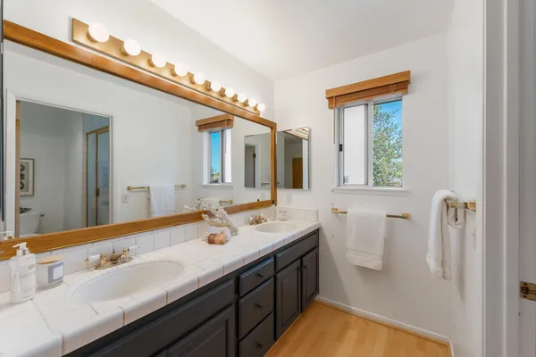 a bathroom with a tub sink and mirror