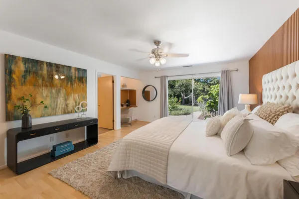 a bedroom with a large bed and a window