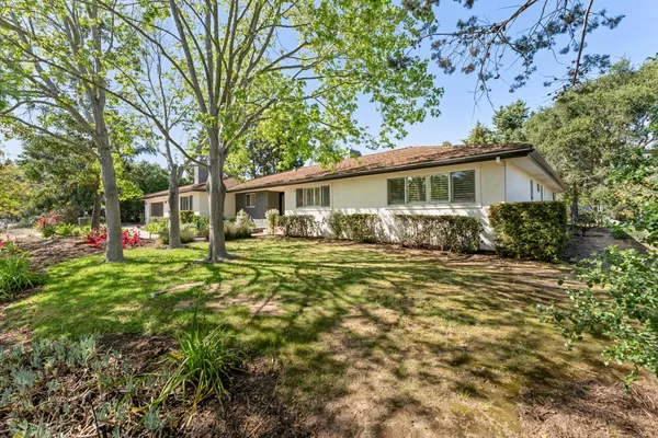 a front view of a house with garden