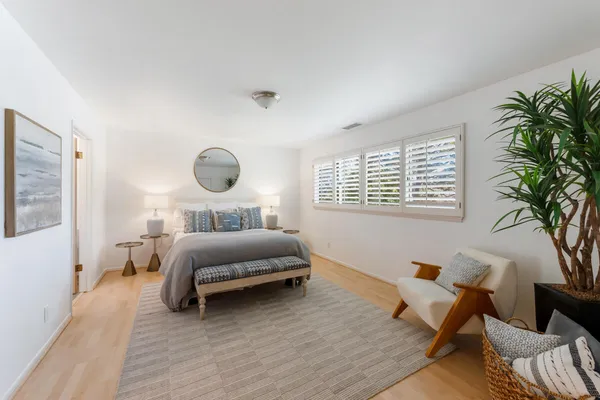 a bedroom with a bed and window