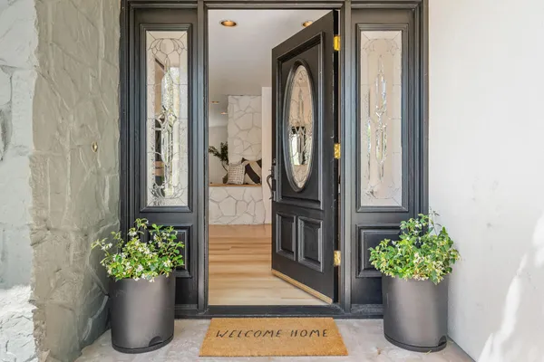 a view of a hallway with potted plant and a chair