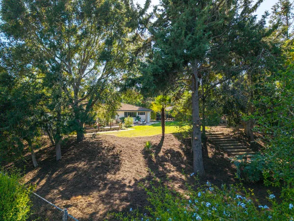 a view of a backyard with swimming pool